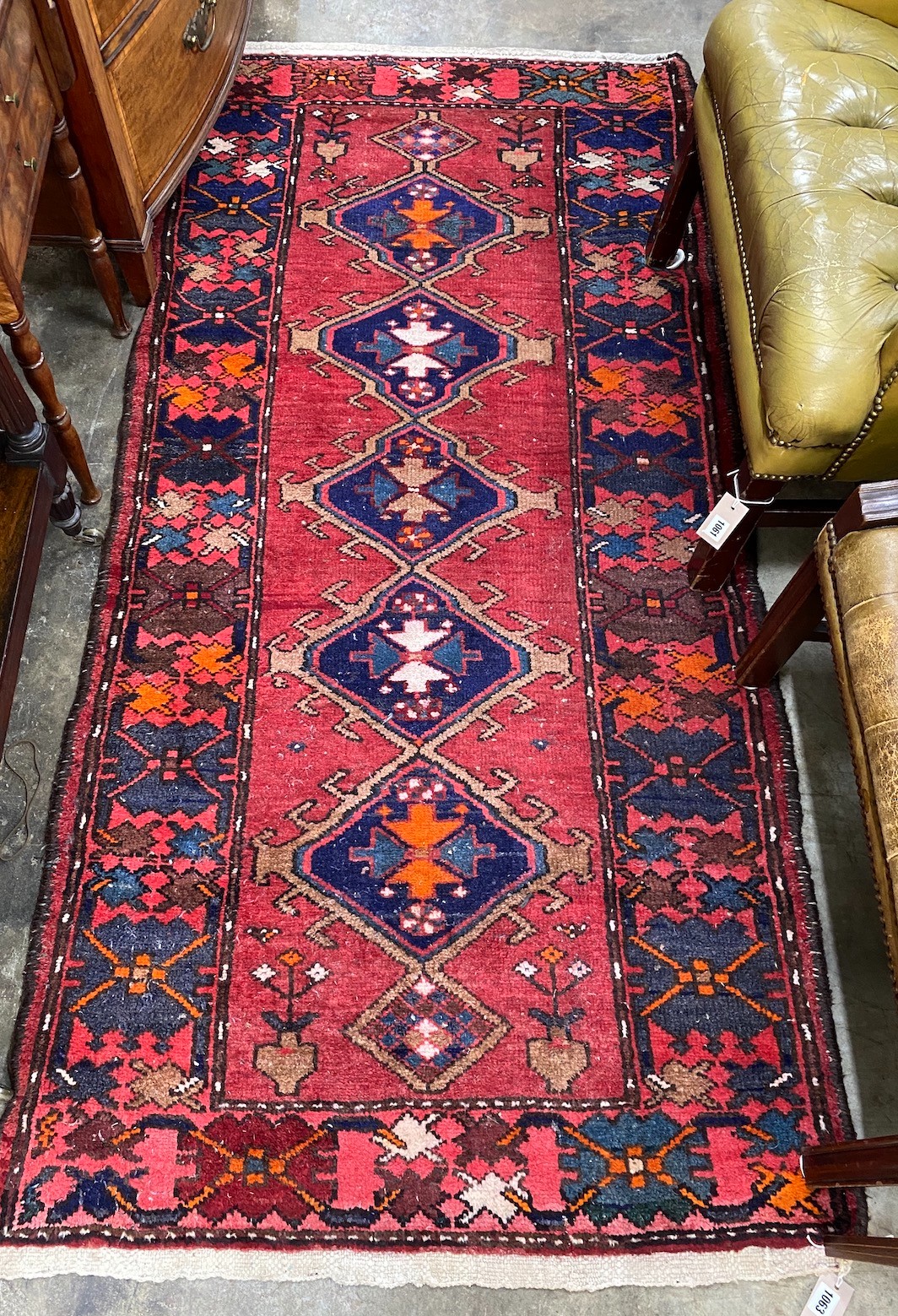 A Caucasian style red ground rug, 200 x 96cm